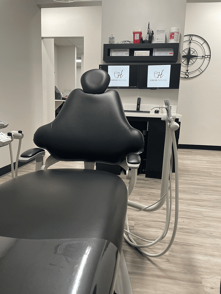 Modern dental operatory with chair and digital monitors at Chemi Dental in Horizon City, TX