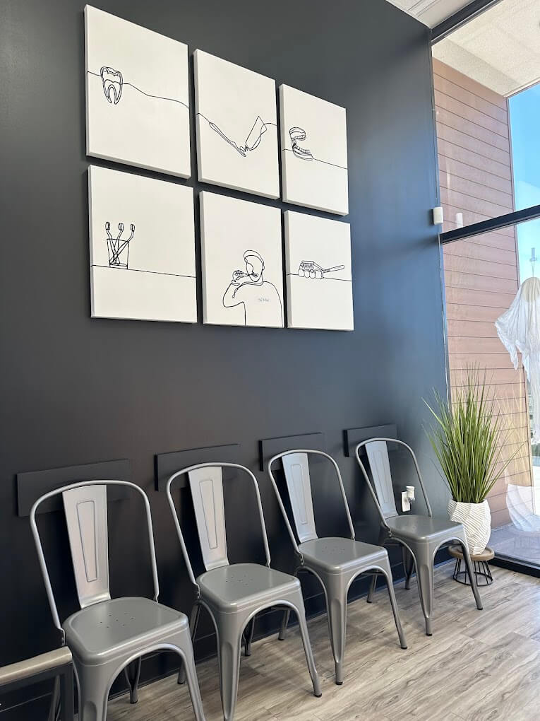 Chemi Dental reception area with seating and dental line-art wall canvases